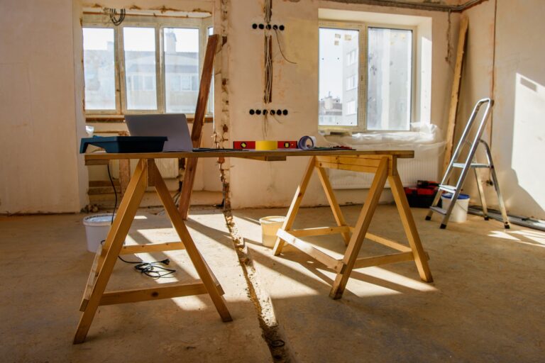 room with scaffold with tools and laptop during renovation of home